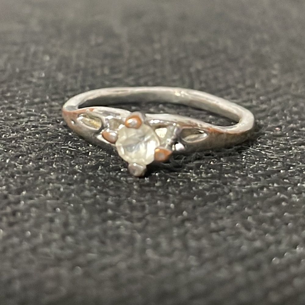 Thin ring with a white gem